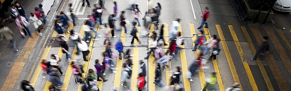 People crossing a busy street in Hong Kong